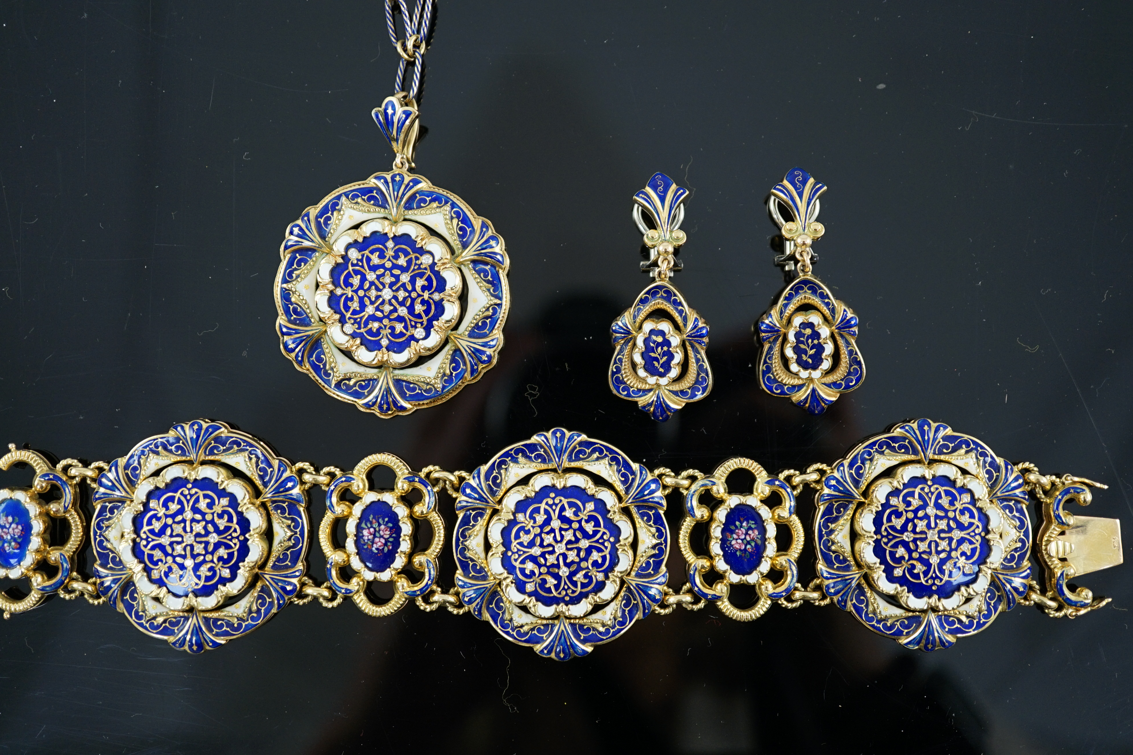 A mid 20th century Swiss 18ct gold and polychrome enamelled suite of jewellery, retailed by E. Meister, Zurich